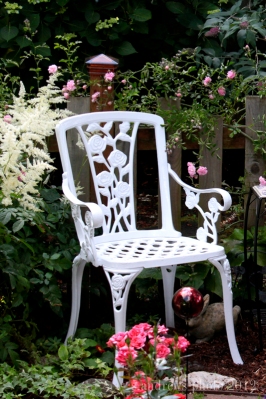 I saw this chair a few years ago and had to have it! It sits in my mini rose garden.